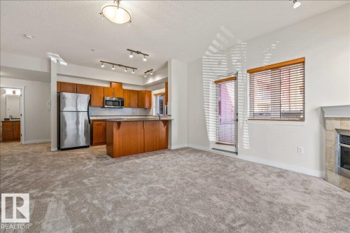 #118 10333 112 St Nw, Edmonton, AB - Indoor Photo Showing Kitchen With Fireplace