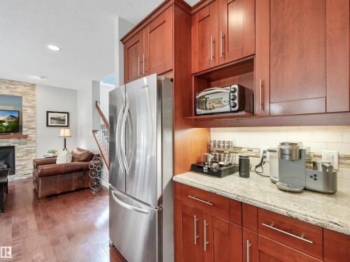 4609 60 Street, Beaumont, AB - Indoor Photo Showing Kitchen With Fireplace