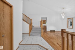 Vaulted ceilings, hardwood flooring, and a crystal chandelier - 