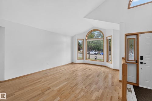 Hardwood flooring, vaulted ceiling, arched window, bay window, and a decorative glass entry door - 306 Twin Brooks Drive Nw, Edmonton, AB 