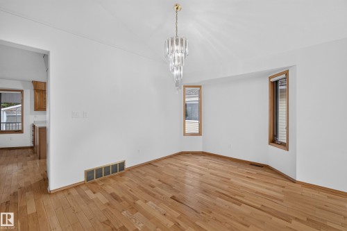 Hardwood flooring, crisp white walls, contemporary chandelier, and integrated bay windows - 306 Twin Brooks Drive Nw, Edmonton, AB 