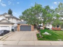 Concrete driveway leading to an attached garage with a dark gray door - 306 Twin Brooks Drive Nw, Edmonton, AB 