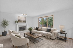 White walls, wood-framed window, fireplace with white mantel, track lighting, and wall-to-wall carpeting - 