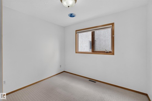 Recessed window with wood-finish trim, neutral wall color, and carpeted flooring - 306 Twin Brooks Drive Nw, Edmonton, AB 