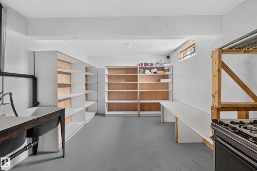 Built-in shelving, utility sink, long workspace, and exposed ceiling beams - 306 Twin Brooks Drive Nw, Edmonton, AB 