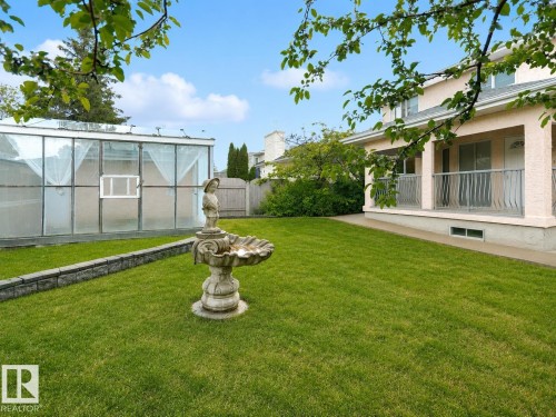 Expansive lawn area with a decorative water feature - 306 Twin Brooks Drive Nw, Edmonton, AB 