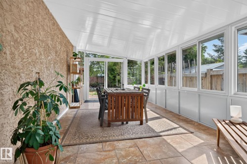 Sunroom featuring tiled flooring, a textured wall, multiple windows, and a white paneled ceiling - 12 Latimer Place, St. Albert, AB - 