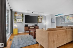Hardwood flooring, track lighting, an expansive window, and a built-in skylight - 