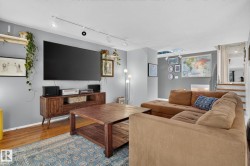 Hardwood flooring, track lighting, and a built-in media console - 