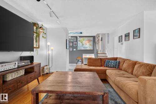 Hardwood flooring, track lighting, and white walls - 12 Latimer Place, St. Albert, AB - Indoor Photo Showing Living Room