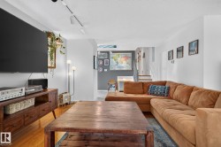 Hardwood flooring, track lighting, and white walls - 