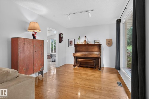 Hardwood flooring throughout, with a large window providing abundant natural light - 12 Latimer Place, St. Albert, AB - Indoor