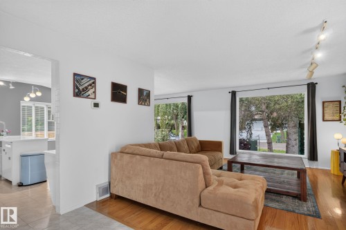 Wood-finish flooring throughout the living area - 12 Latimer Place, St. Albert, AB - Indoor Photo Showing Living Room