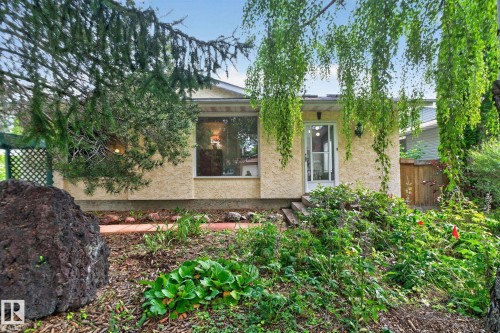 Stucco exterior with a prominent picture window and a glass-paneled entry door - 12 Latimer Place, St. Albert, AB - Outdoor