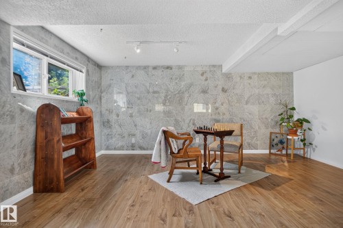 Wood-finish flooring, recessed lighting, expansive wall tiling, and a window with natural light - 12 Latimer Place, St. Albert, AB - Indoor