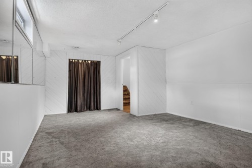 Carpeted flooring with white paneling and a drop ceiling - 12 Latimer Place, St. Albert, AB - Indoor Photo Showing Other Room