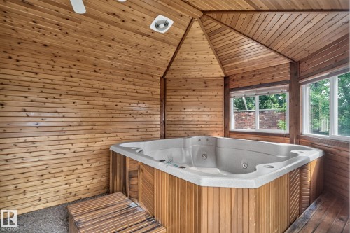 Enclosed hot tub area featuring wood-paneled walls and ceiling - 12 Latimer Place, St. Albert, AB - Indoor Photo Showing Bathroom