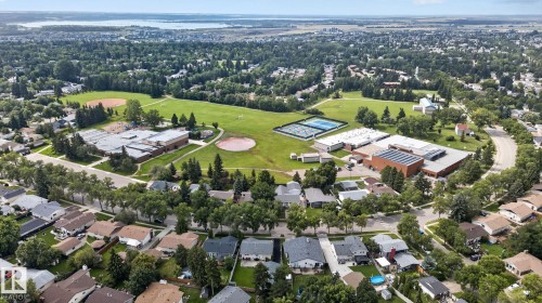 Aerial perspective showcasing an expansive green space with sports fields, tennis courts, and mature trees - 12 Latimer Place, St. Albert, AB - Outdoor With View