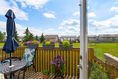 Wooden deck featuring a sliding glass door and perimeter railing - #9 6506 47 St, Cold Lake, AB - Outdoor With Deck Patio Veranda