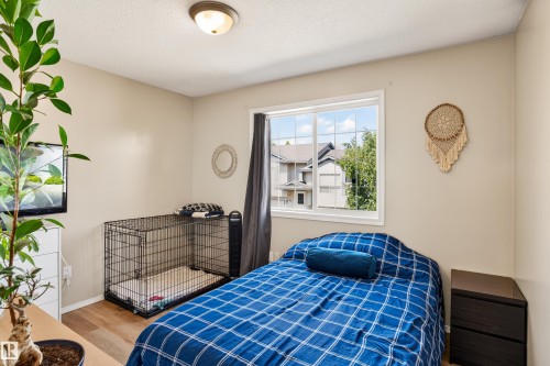 Recessed lighting fixture, light neutral wall color, wood-finish flooring, white trim window - #9 6506 47 St, Cold Lake, AB - Indoor Photo Showing Bedroom