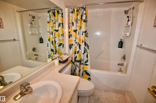Bathtub-shower combination with a single-handle faucet - #706 9741 110 St Nw, Edmonton, AB - Indoor Photo Showing Bathroom