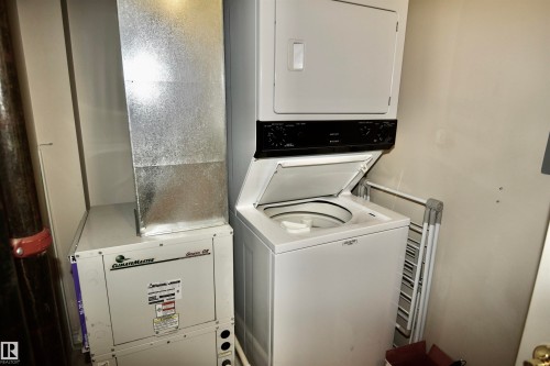 Stacked washer and dryer unit - #706 9741 110 St Nw, Edmonton, AB - Indoor Photo Showing Laundry Room