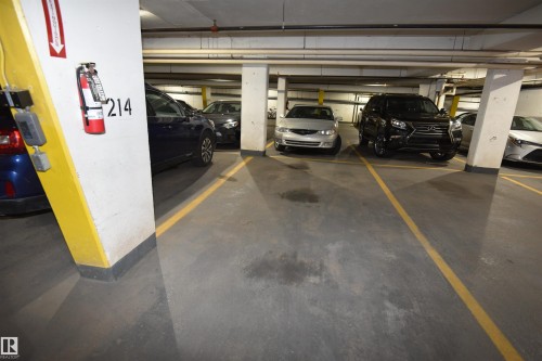 Underground parking space with designated yellow striping - #706 9741 110 St Nw, Edmonton, AB - Indoor Photo Showing Garage