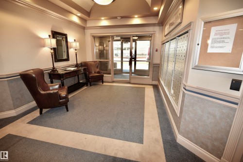 Lobby featuring carpet flooring, recessed lighting, and a mail center - #706 9741 110 St Nw, Edmonton, AB - Indoor Photo Showing Other Room