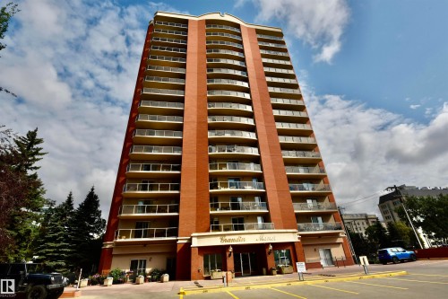 Brick facade high-rise with multiple floors of private balconies featuring glass railings - #706 9741 110 St Nw, Edmonton, AB - Outdoor With Balcony With Facade