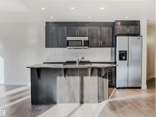 #304 11933 Jasper Av Nw, Edmonton, AB - Indoor Photo Showing Kitchen With Upgraded Kitchen