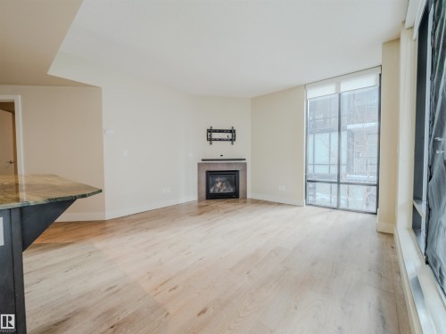 #304 11933 Jasper Av Nw, Edmonton, AB - Indoor Photo Showing Other Room With Fireplace