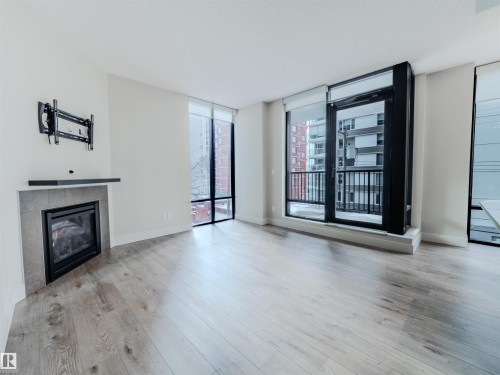 #304 11933 Jasper Av Nw, Edmonton, AB - Indoor Photo Showing Living Room With Fireplace