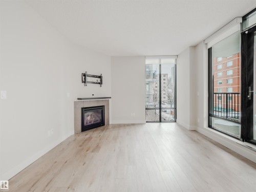 #304 11933 Jasper Av Nw, Edmonton, AB - Indoor Photo Showing Living Room With Fireplace