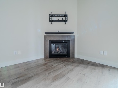 #304 11933 Jasper Av Nw, Edmonton, AB - Indoor Photo Showing Living Room With Fireplace