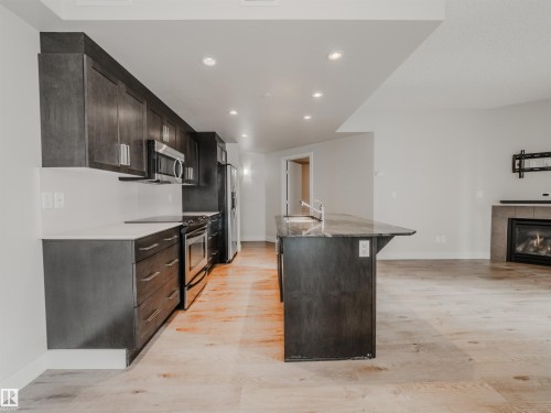 #304 11933 Jasper Av Nw, Edmonton, AB - Indoor Photo Showing Kitchen With Fireplace With Upgraded Kitchen