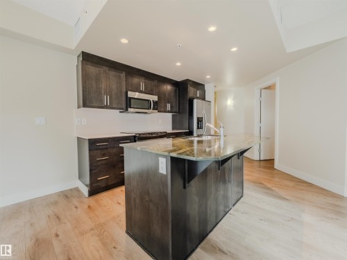 #304 11933 Jasper Av Nw, Edmonton, AB - Indoor Photo Showing Kitchen With Upgraded Kitchen