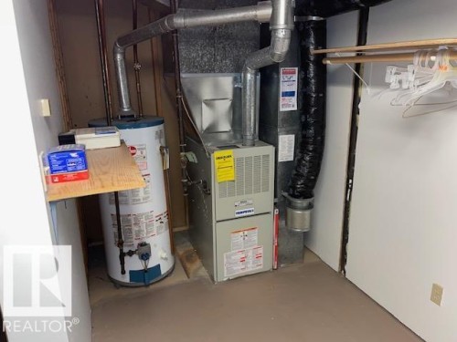 Utility area featuring a water heater, furnace, and exposed ductwork - 27 Gatewood Avenue, St. Albert, AB - Indoor Photo Showing Basement