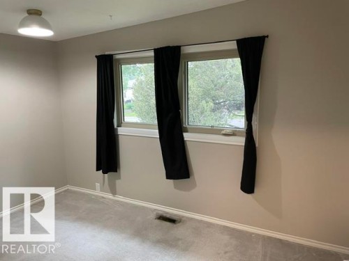 Two windows with white trim, light gray walls, and light gray carpeting - 27 Gatewood Avenue, St. Albert, AB - Indoor Photo Showing Other Room
