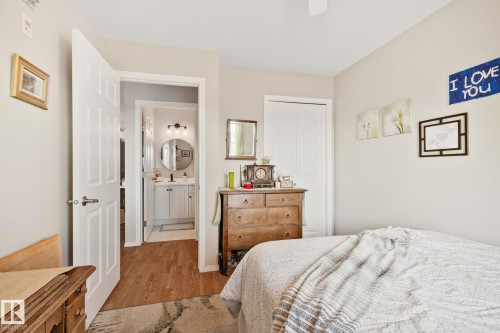 Neutral wall paint, white paneled doors, and a ceiling fan - #407 4309 33 St, Stony Plain, AB - Indoor Photo Showing Bedroom
