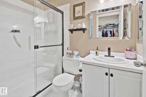 Enclosed shower with a black-framed glass door - #407 4309 33 St, Stony Plain, AB - Indoor Photo Showing Bathroom