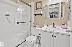 Enclosed shower with a black-framed glass door - 