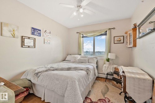 Wood-finish flooring with a ceiling fan overhead - #407 4309 33 St, Stony Plain, AB - Indoor Photo Showing Bedroom