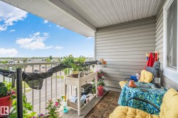 Balcony with a perforated soffit, horizontal siding, and metal railings - 