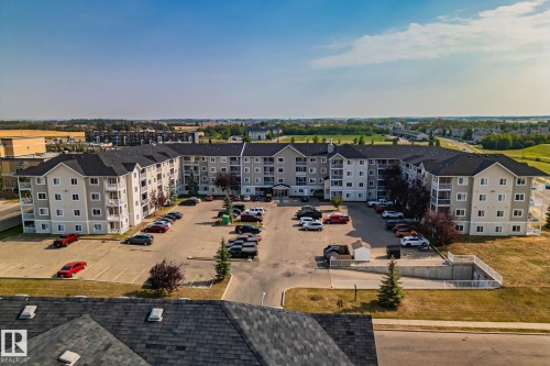 Multi-story residential building with private balconies and surface parking - #407 4309 33 St, Stony Plain, AB - Outdoor With View