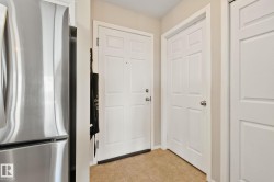 Entryway featuring panel doors, neutral wall tones, and tiled flooring - 