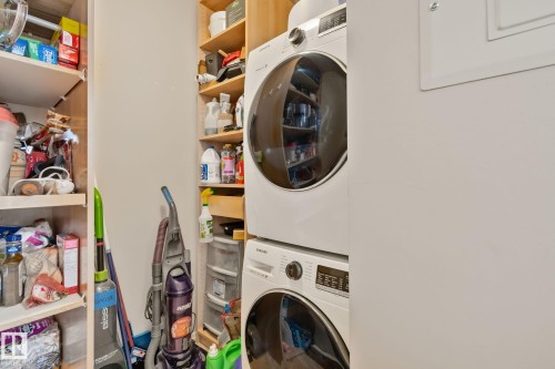 Integrated laundry appliances with wood-finish shelving - #407 4309 33 St, Stony Plain, AB - Indoor Photo Showing Laundry Room