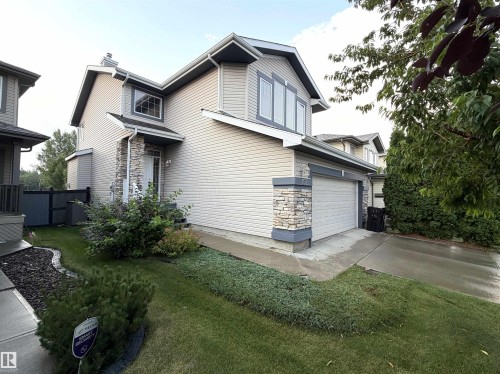 Two-story exterior with light-colored siding and dark trim accents - 192 Keyport Circle, Leduc, AB - Outdoor