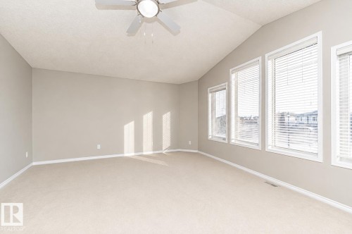 Vaulted ceiling with a ceiling fan, multiple windows with blinds, and neutral carpet flooring - 192 Keyport Circle, Leduc, AB - Indoor Photo Showing Other Room