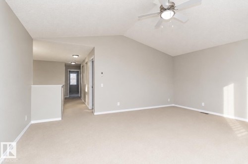 Vaulted ceiling with a ceiling fan, carpeted flooring, and a hallway featuring recessed lighting - 192 Keyport Circle, Leduc, AB - Indoor Photo Showing Other Room