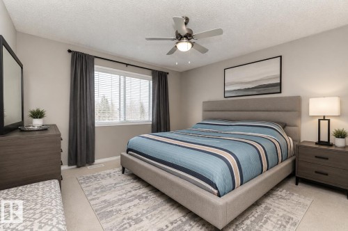 Staged With AI - Recessed window with white blinds, neutral wall paint, ceiling fan with integrated lighting, and wall-to-wall carpeting - 192 Keyport Circle, Leduc, AB - Indoor Photo Showing Bedroom